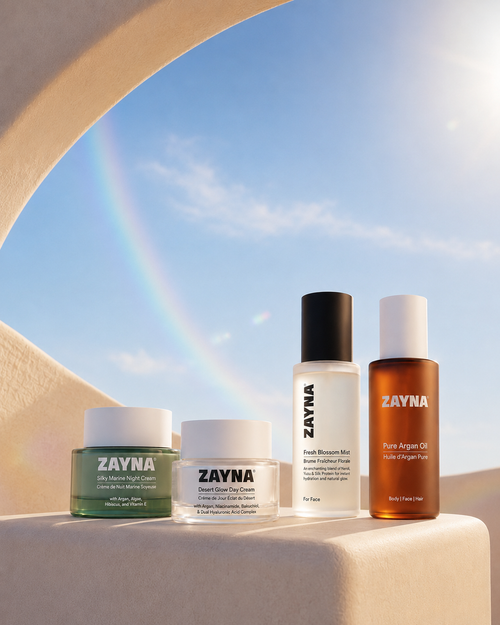 The ZAYNA Signature Set: night cream, day cream, face mist and argan oil under a desert arch